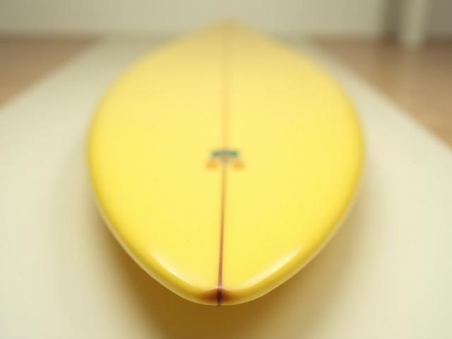 Retro-style fish surfboard, yellow deck, swallow tail, with classic artwork.