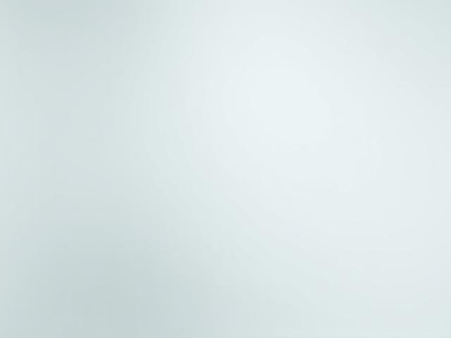 A gleaming white epoxy surfboard reflecting sunlight, showcasing its lightweight and durable finish.